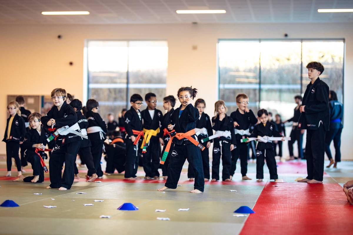 Ninja School students practising kicks in a line